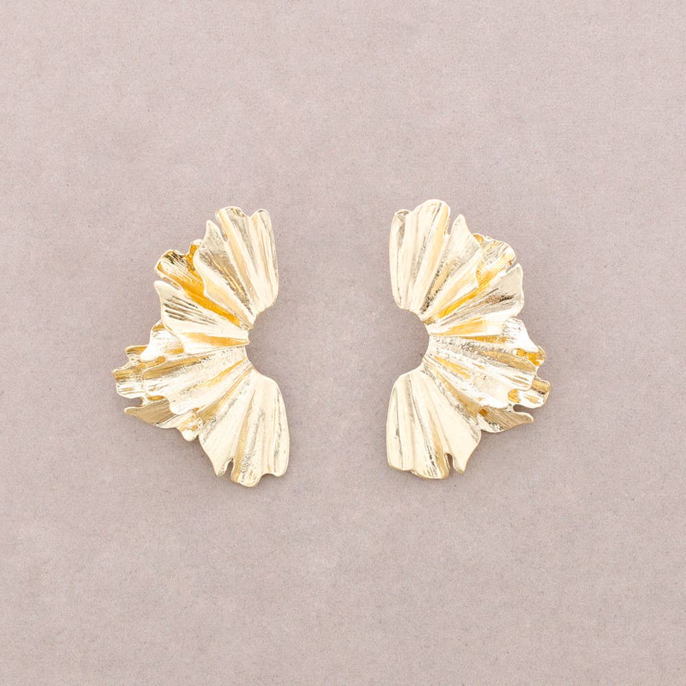 Pair of gold earrings on a light gray background