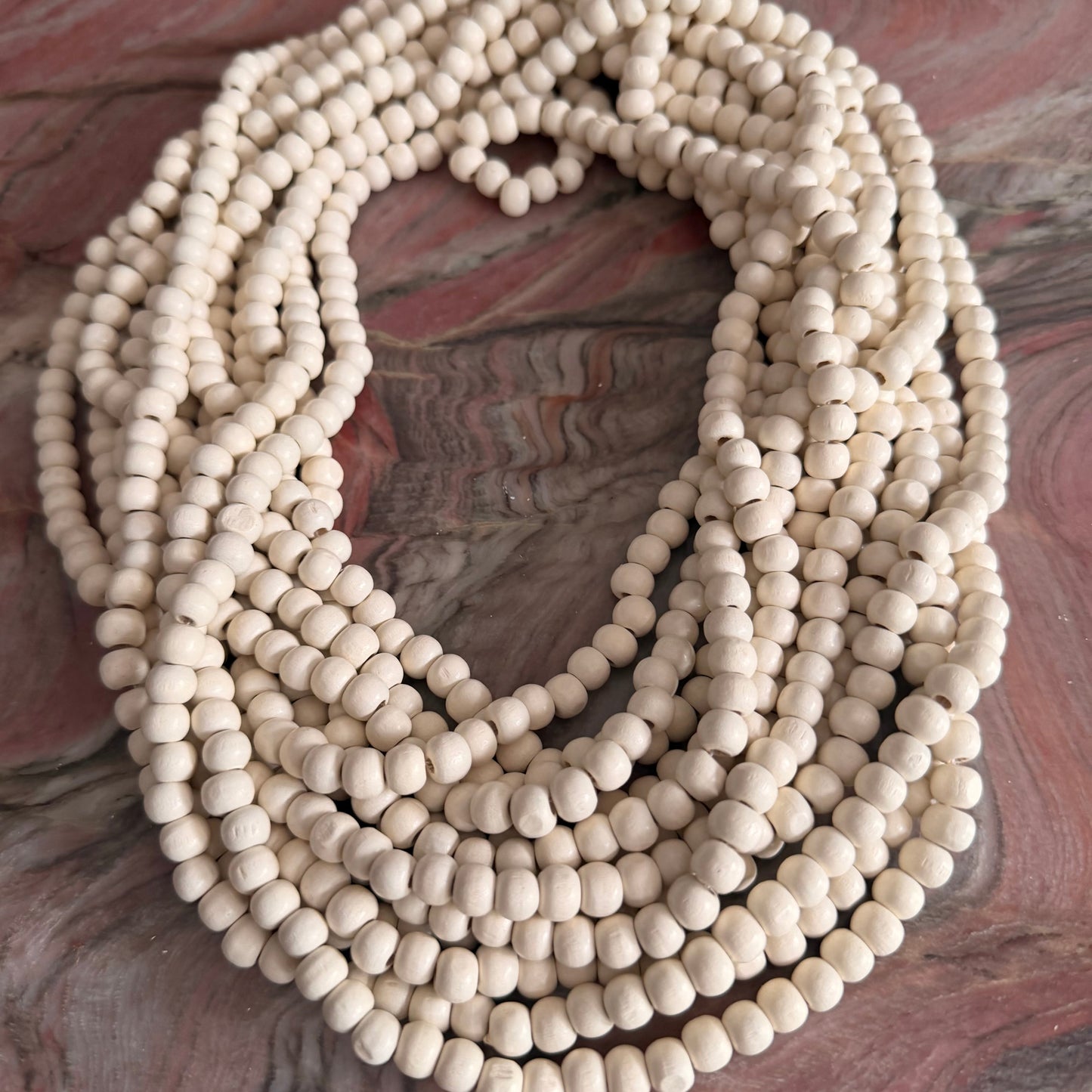 String of white beads on a textured surface