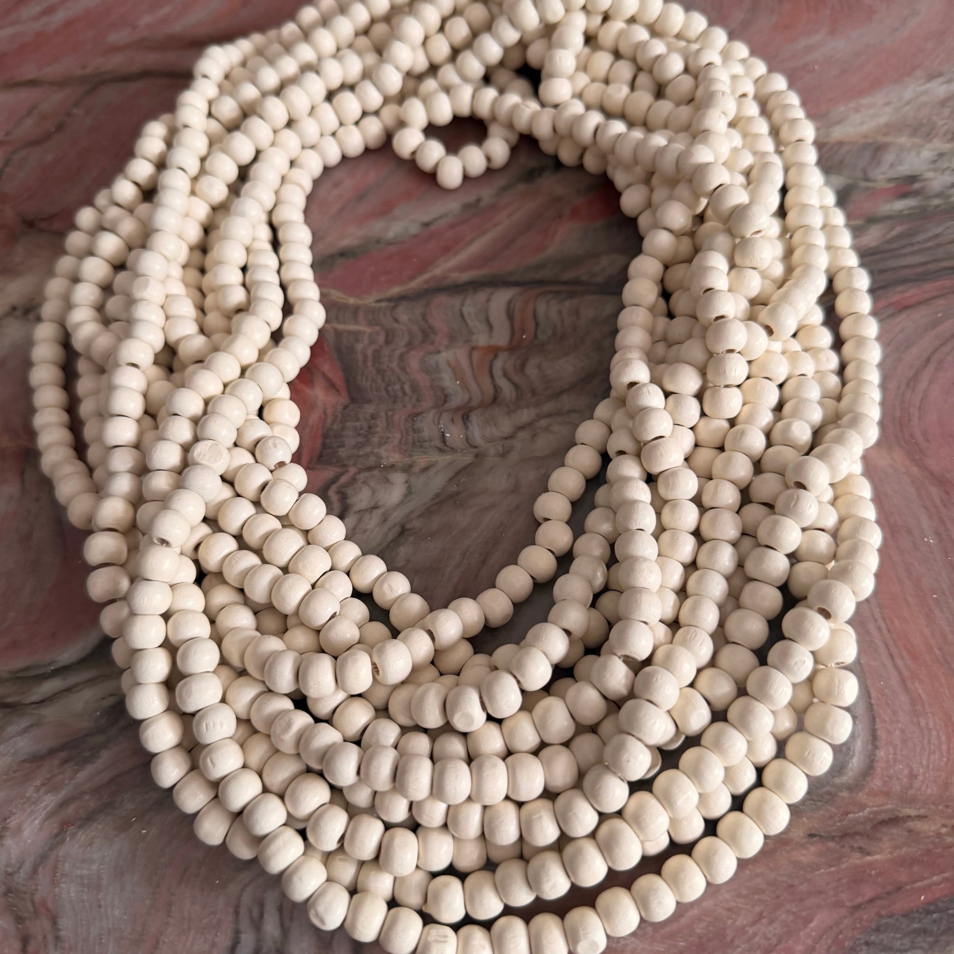 String of white beads on a textured surface