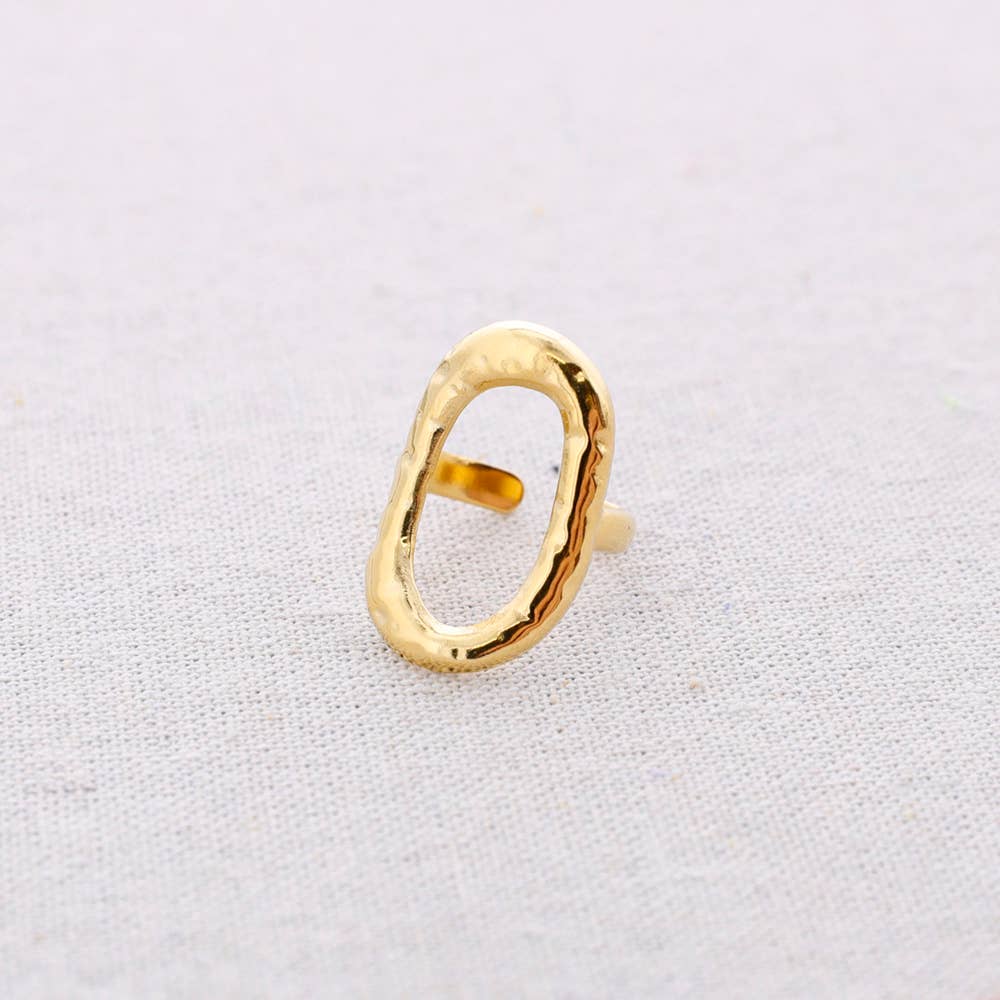 Gold ring on a light gray background